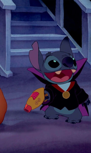 A cute Stitch Halloween wallpaper featuring Stitch dressed in a vampire costume, holding a laser blaster on a spooky staircase