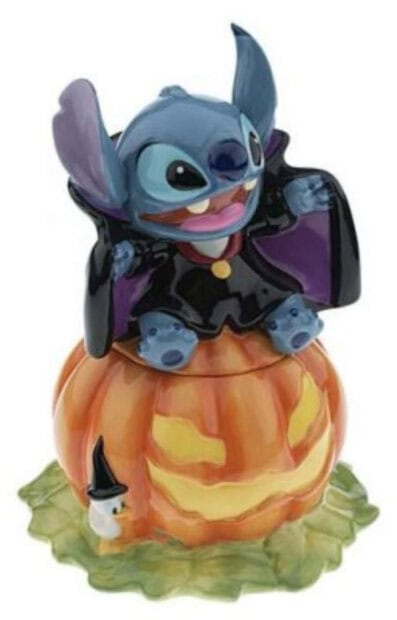 A unique Stitch Halloween wallpaper showing a Stitch vampire figurine sitting atop a glowing jack-o'-lantern pumpkin