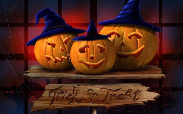 A 3D Halloween Wallpaper showing three smiling pumpkins wearing witch hats on a wooden sign that says 