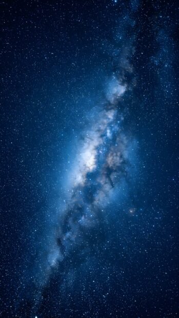 A serene abstract space wallpaper blue depicting a clear view of a milky way galaxy arm with bright stars and cosmic dust