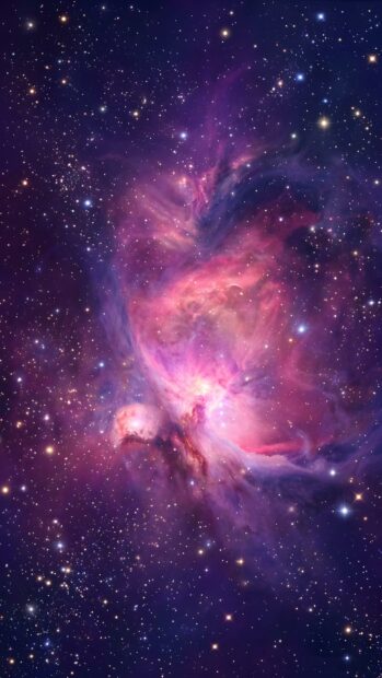 An abstract starfield wallpaper featuring a vibrant, colorful nebula with pink, purple, and red hues amidst countless stars
