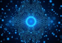 An Abstract Tech Wallpaper Blue depicting a central glowing blue circuit board brain or core surrounded by radiating lines and bokeh lights on a dark background