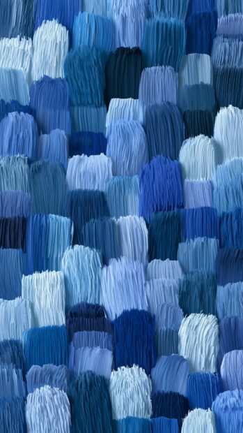 A blue aesthetic wallpaper showcasing a textured pattern of small, shaggy blocks in various shades of blue
