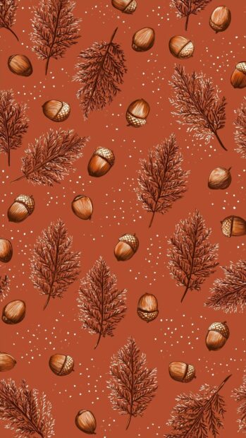 A cute fall wallpaper showcasing a scattered pattern of acorns and various autumn leaves on a warm terracotta background with small white speckles