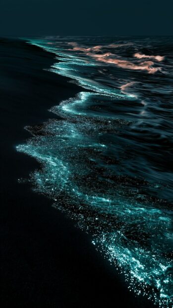 Dark aesthetic wallpaper featuring glowing bioluminescent waves crashing on a dark ocean beach at night