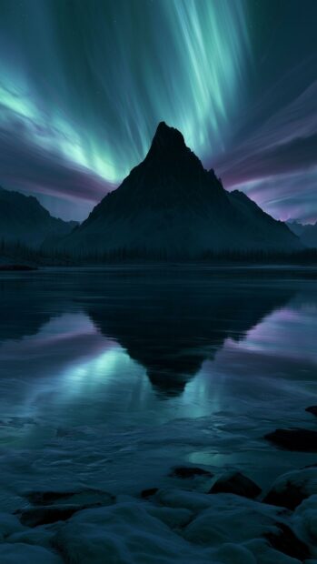 Dark aesthetic wallpaper depicting a majestic mountain reflecting in a lake under a vibrant aurora borealis sky