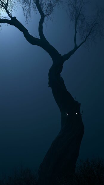 Dark Aesthetic Wallpaper featuring a mysterious gnarled tree with glowing white eyes in a dark blue foggy setting
