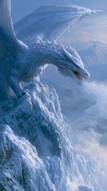 Majestic white ice dragon wallpaper perched atop a snowy mountain peak amidst clouds