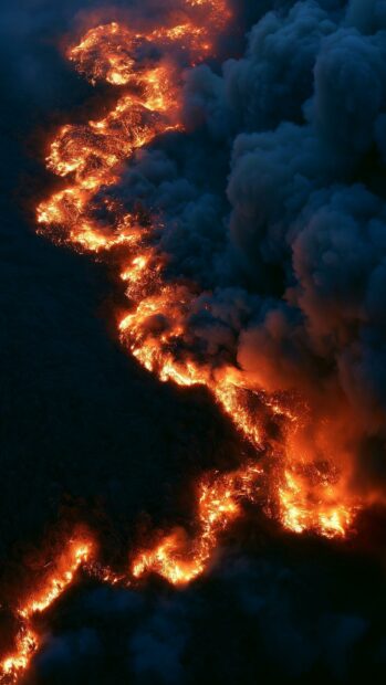 A dramatic fire wallpaper showing an aerial view of a winding fire trail with thick dark smoke
