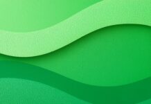 An abstract green aesthetic wallpaper featuring smooth, wavy layers in various shades of green with a subtle textured surface