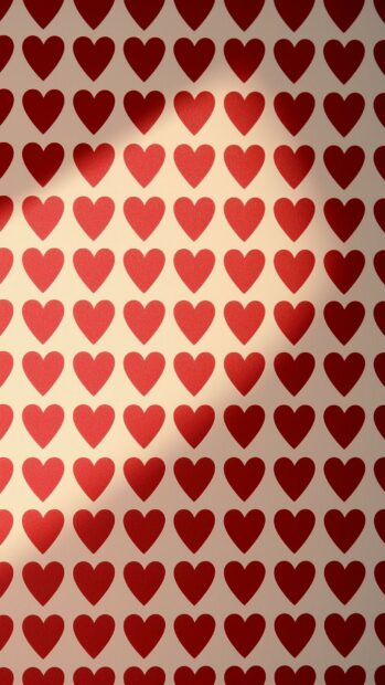 A delightful hearts wallpaper featuring a repeating pattern of bright red hearts on a light beige background