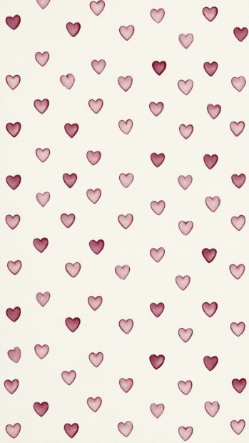 An aesthetic hearts wallpaper featuring a scattered pattern of watercolor pink and maroon hearts on a textured light cream background