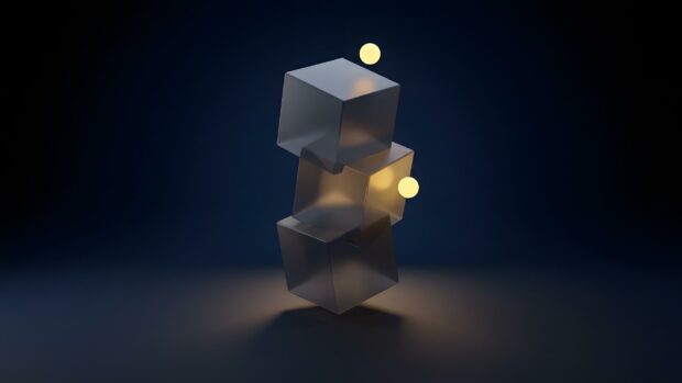 A captivating minimalist wallpaper showcasing three translucent abstract cubes stacked vertically, illuminated by golden glowing spheres on a dark blue background. This design offers a modern, clean look