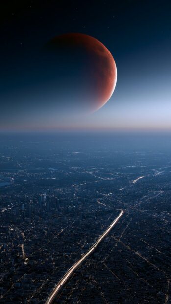 Dramatic Moon Wallpaper featuring a red blood moon hovering over a sprawling city with a bright highway at night