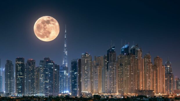 A stunning moon wallpaper featuring the Dubai city skyline with the Burj Khalifa towering under a large full moon