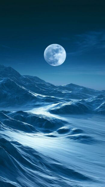 A serene moon wallpaper featuring a full moon over vast snowy mountains under a deep blue sky
