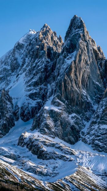 Mountain wallpaper featuring stunning snow-capped peaks under a clear blue sky
