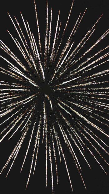 An abstract New Year Aesthetic Wallpaper featuring a starburst fireworks explosion with white light streaks on a dark background
