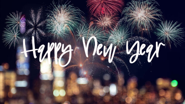 A festive New Year Aesthetic Wallpaper with "Happy New Year" text overlaid on a blurred background of fireworks and city lights