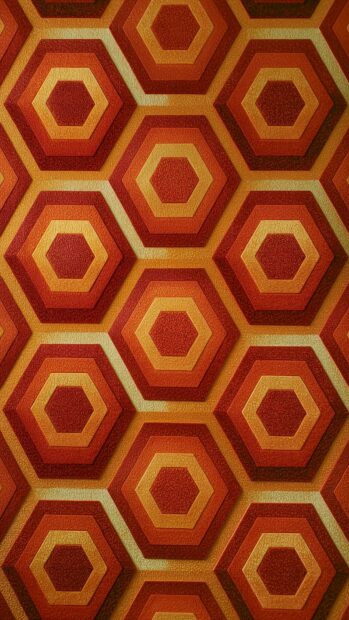 A retro wallpaper showcasing a classic geometric pattern of concentric hexagons in warm orange and red tones