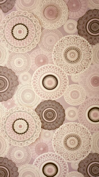 Retro wallpaper featuring intricate lace-like circular patterns in shades of pink, cream, and brown