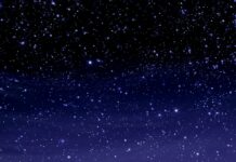 A mesmerizing Stars Wallpaper depicting a sparkling night sky with countless small stars fading from black to deep blue