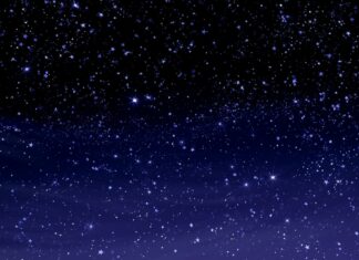 A mesmerizing Stars Wallpaper depicting a sparkling night sky with countless small stars fading from black to deep blue