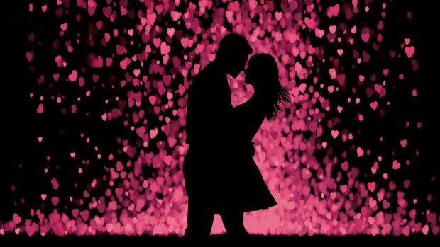 Dark aesthetic Valentines Day wallpaper featuring a silhouette couple kissing against a backdrop of glowing pink hearts