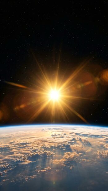 Sunrise over Earth's horizon creating a striking solar flare effect