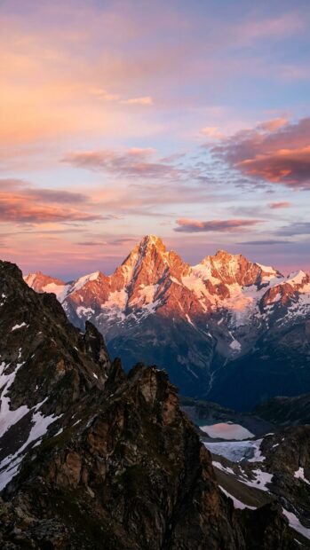 A mountain range at sunset with colorful clouds in the sky