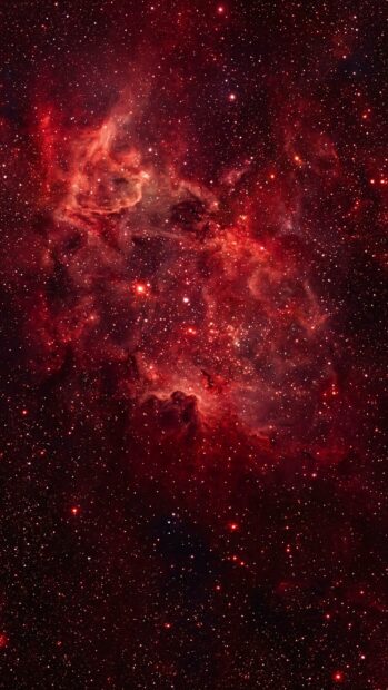 A vibrant red galaxy filled with stars, creating a stunning red aesthetic wallpaper