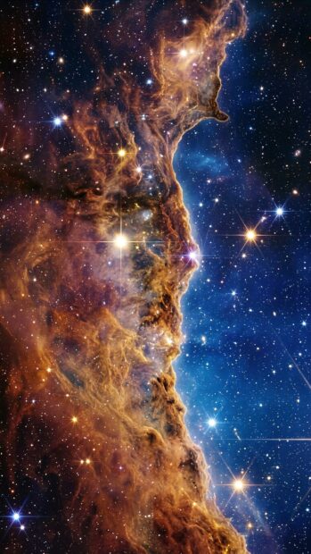 A starfield with a golden nebula edge and bright stars