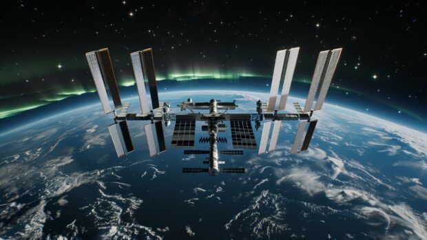 A breathtaking view of the International Space Station with auroras visible below it on Earth wallpaper HD for PC.