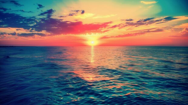 A vibrant sunset over a serene ocean with colorful reflections on the water, 4K desktop wallpaper.