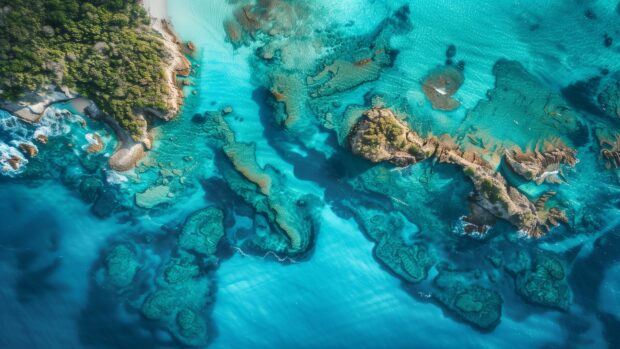 An aerial view of the ocean with visible currents and a clear blue sky.