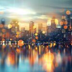 City skyline at night with cool twinkling lights and reflections.