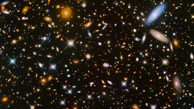 Download Free Space desktop background with A vibrant starfield wallpaper with numerous stars, galaxies, and nebulae spread across the sky.