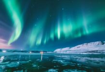HD Northern Lights Desktop Wallpaper in various shades of green and purple over an icy landscape.