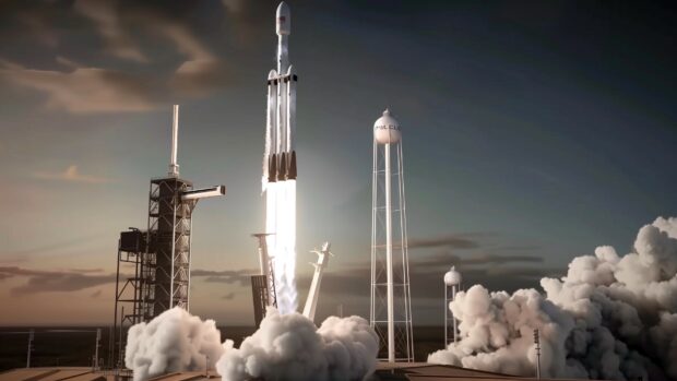 HD wallpaper with a dramatic view of a SpaceX Falcon Heavy rocket during liftoff, with all three boosters firing and the ground shaking below.