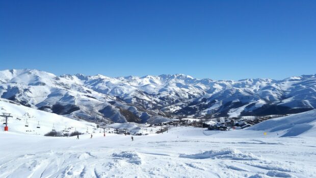Snow covered mountains under a clear blue sky, pristine white slopes, Nature Wallpaper desktop.