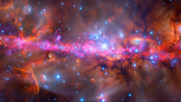 Space desktop background with a stunning view of a galactic core with dense star clusters and bright light radiating outward.