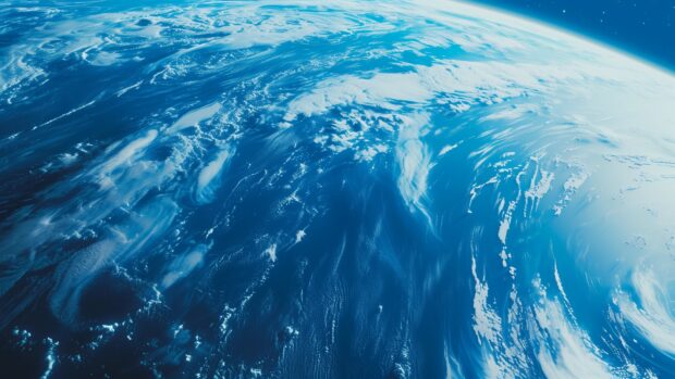 Space desktop background with an epic view of a blue planet with swirling clouds and oceans, set against the backdrop of the deep blue cosmos.