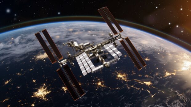 The ISS passing over a vibrant, colorful Earth, with city lights visible on the dark side.