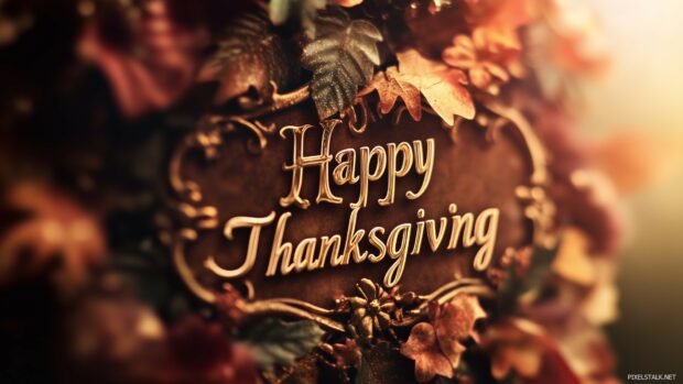 Elegant Thanksgiving wallpaper featuring a sophisticated script Happy Thanksgiving with gold accents.