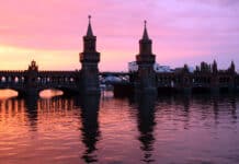 Pier Berlin at sunset with historic bridge and reflected water, colorful sky, Germany, architecture, travel, scenic view.