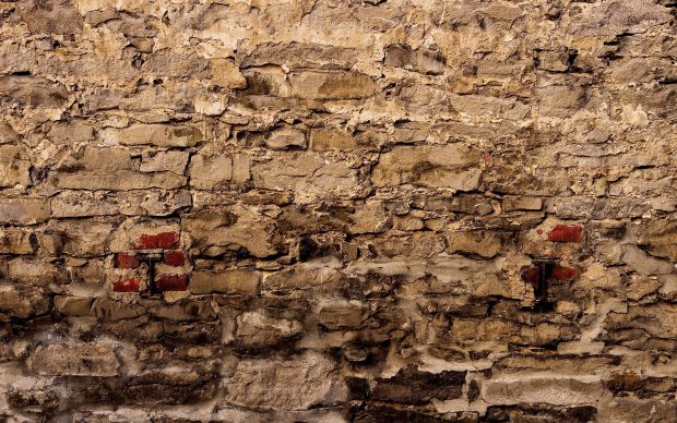 Brick supports in old stone wall.