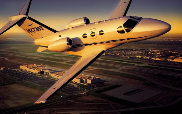 Cessna citation mustang over airport wide.