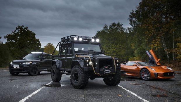 James Bond jaguar c x75 with range rover sports and defender backgrounds.