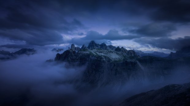 Mountain evening fog cliff dark clouds.