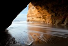 Rock cave ocean beach.